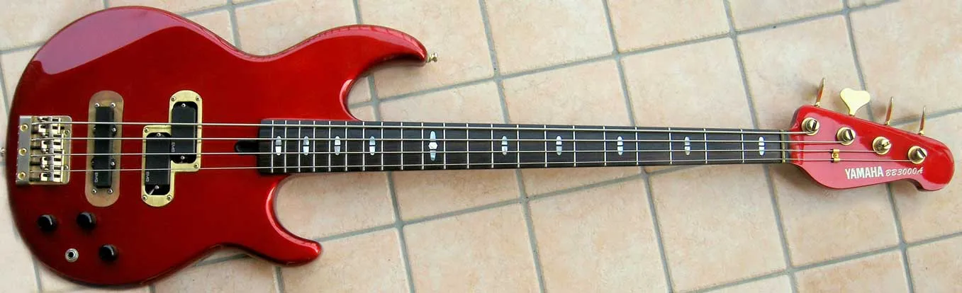 A Candy Apple Red Yamaha BB3000A bass guitar customized with active EMG pickups.
